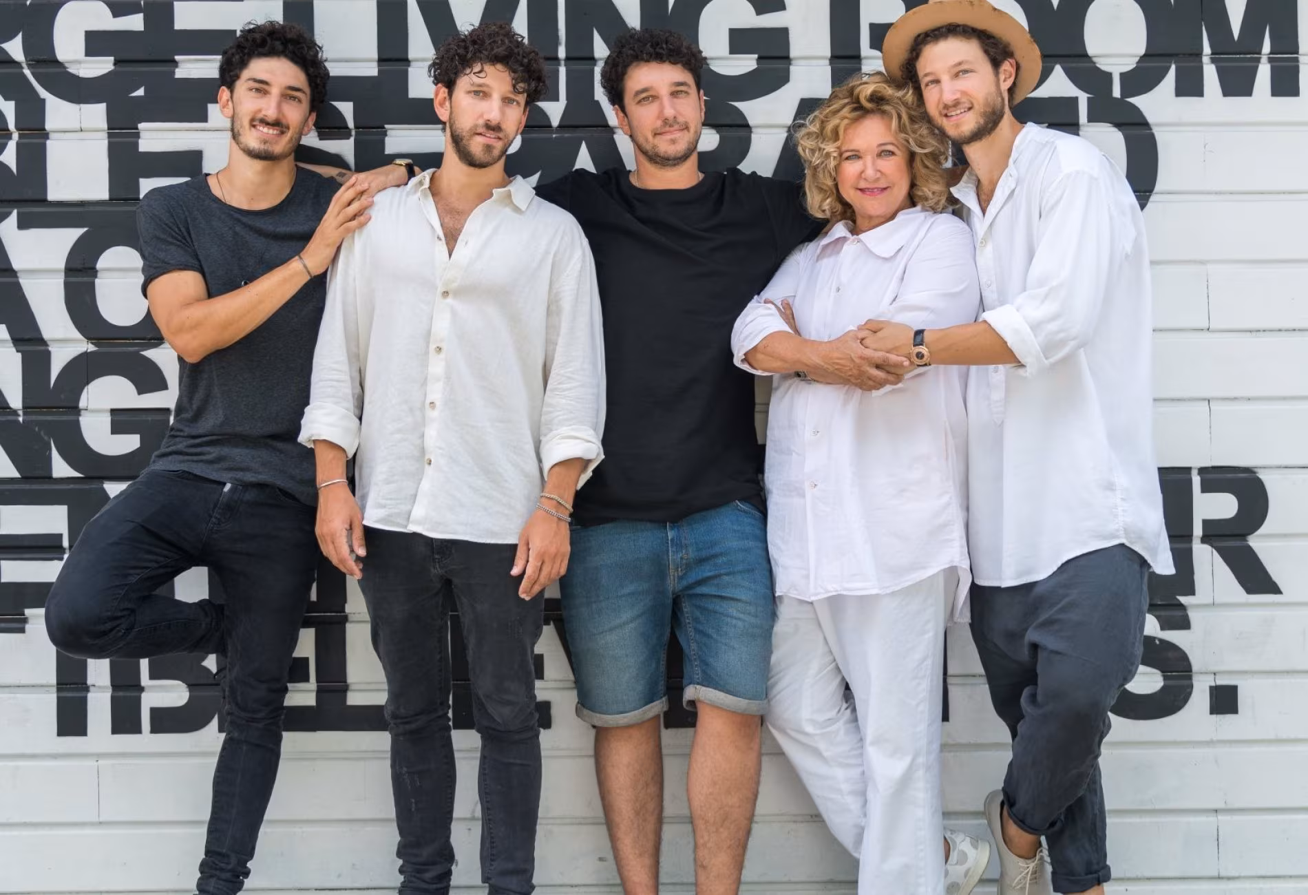 Haya Molcho with her four sons Nuriel, Elior, Nadiv and Ilan in front of a graphic wall