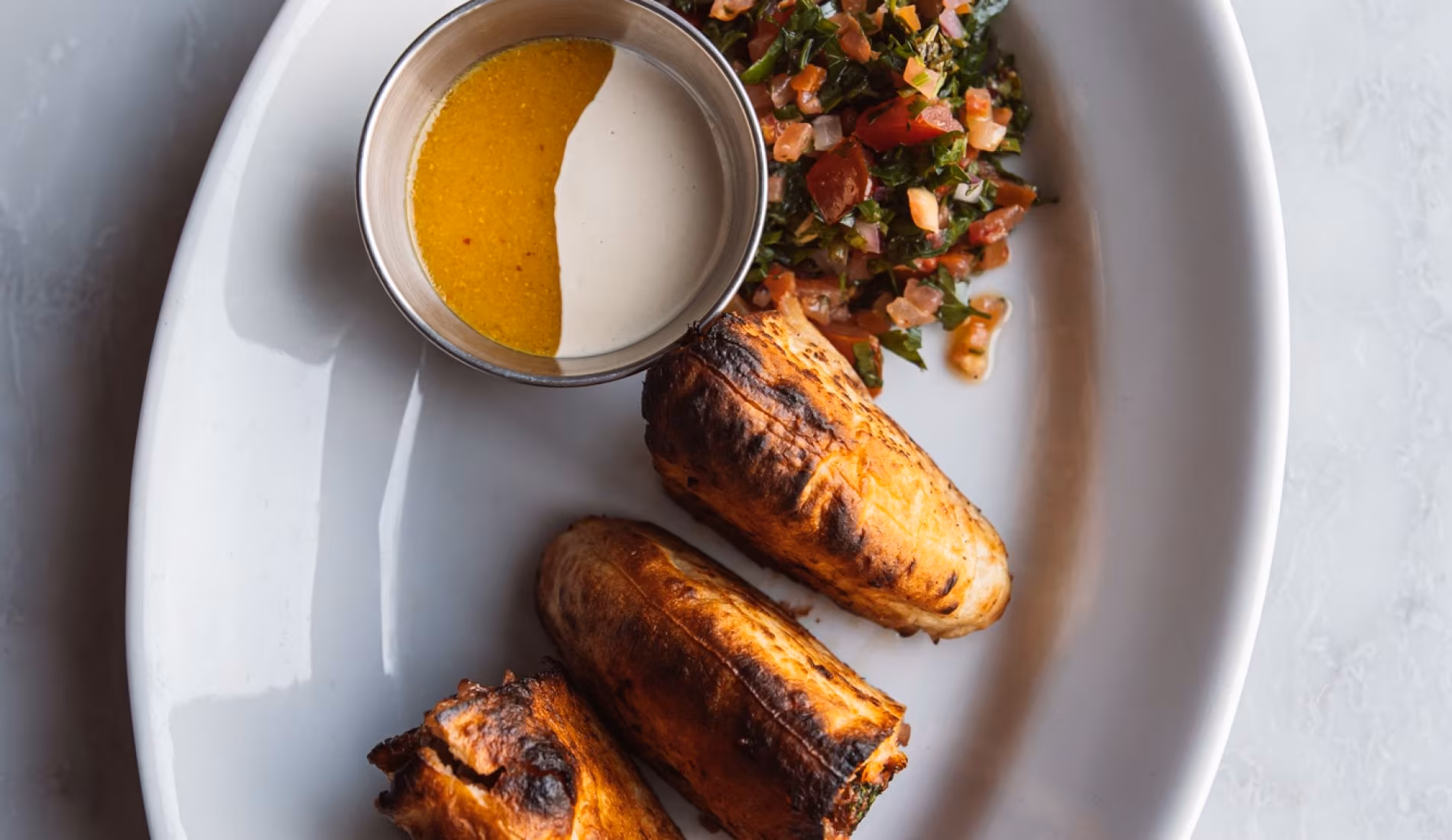 Plate of grilled leeks with a two-tone dip
