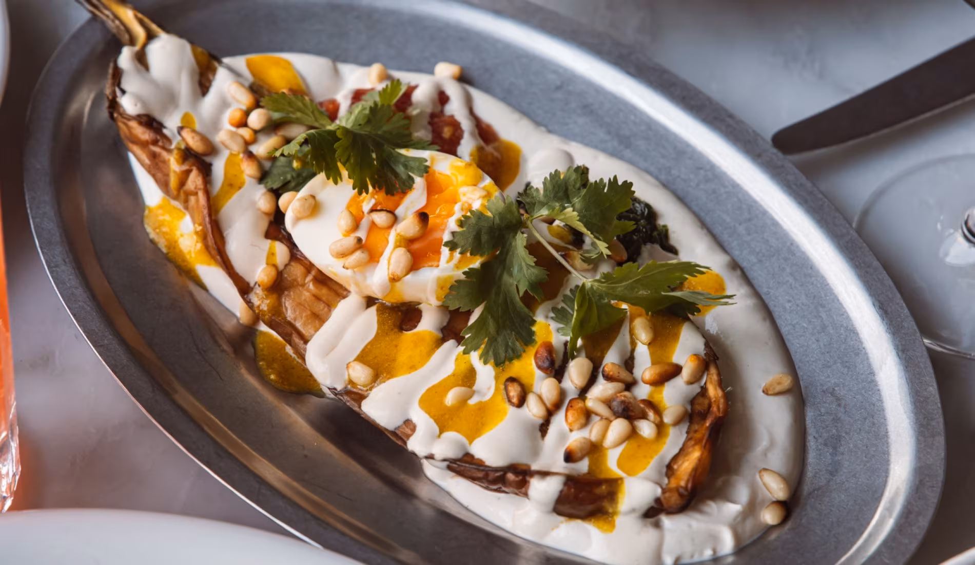 Dish of vegetables with yoghurt, herbs and chilli oil